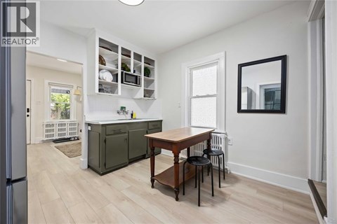 A kitchen with a table and chairs in the middle of the room.
