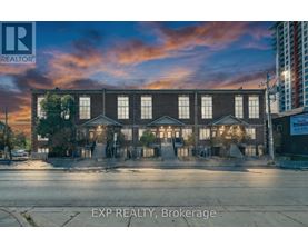 A building with the sign EXP REALTY, Brokerage in front of it.