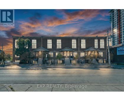 A building with the sign EXP REALTY, Brokerage in front of it.