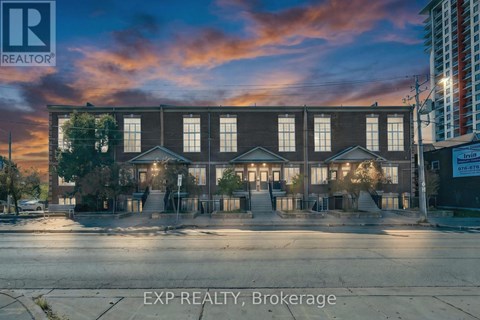 A building with the sign EXP REALTY, Brokerage in front of it.