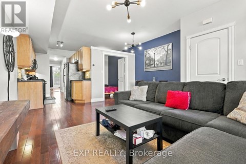 A living room with a grey couch and a coffee table.