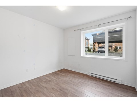 Empty room with a window showing a street view.