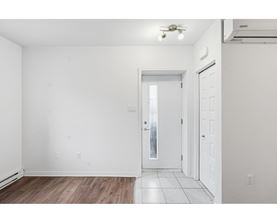 A room with a white door and a window.