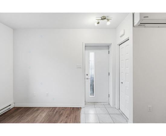 A room with a white door and a window.