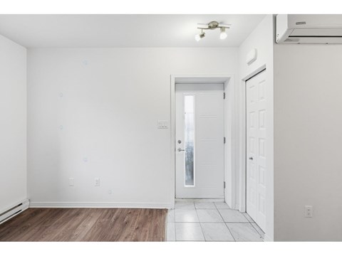 A room with a white door and a window.