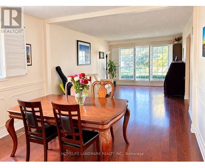 A dining room with a table and chairs.