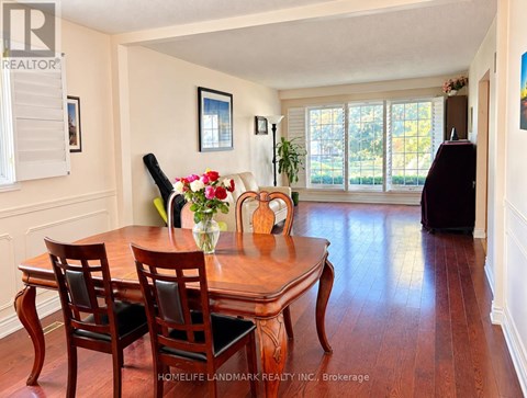 A dining room with a table and chairs.