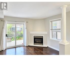 A room with a fireplace and a sliding glass door leading to a backyard.