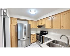 A kitchen with wooden cabinets and stainless steel appliances.
