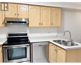 A kitchen with wooden cabinets and a stove top oven.