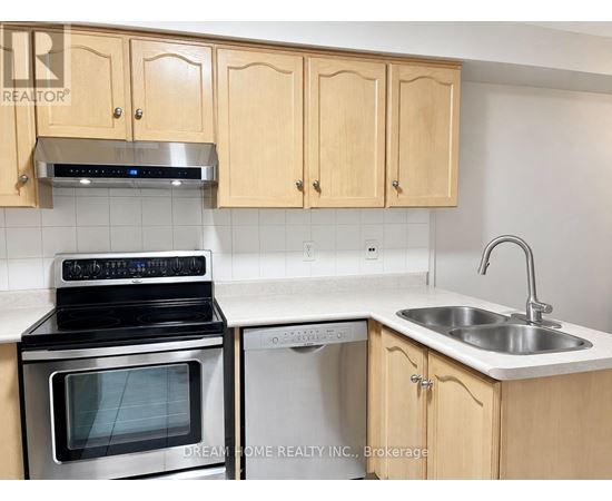 A kitchen with wooden cabinets and a stove top oven.