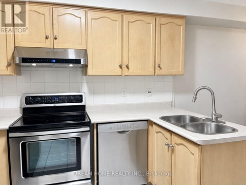 A kitchen with wooden cabinets and a stove top oven.
