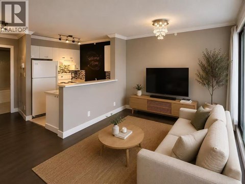 A living room with a couch, a coffee table, and a television.