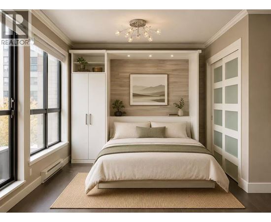 A bedroom with a bed, a rug, and a picture on the wall.