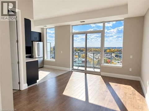 A spacious living room with a view of the city through large windows.
