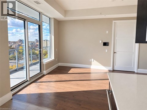 A room with a large window overlooking a cityscape.