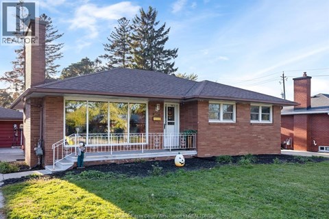 A house with a red brick exterior and a white door.