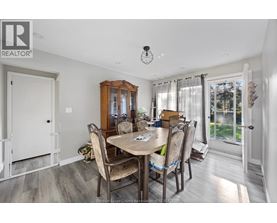 A dining room with a table set for four.