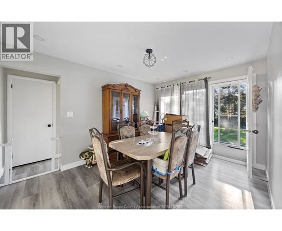 A dining room with a table set for four.