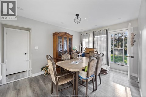 A dining room with a table set for four.