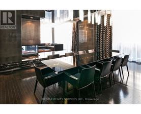 A dining room with a table and chairs.