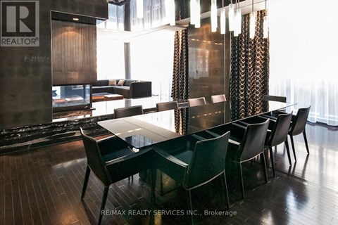A dining room with a table and chairs.