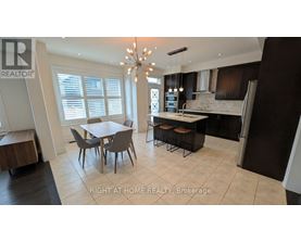 A well-lit kitchen with a dining table and chairs.
