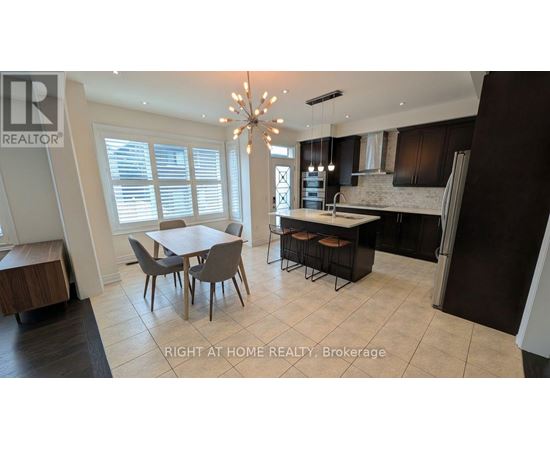 A well-lit kitchen with a dining table and chairs.