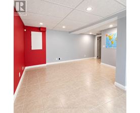 A room with red and grey walls and a world map on the wall.