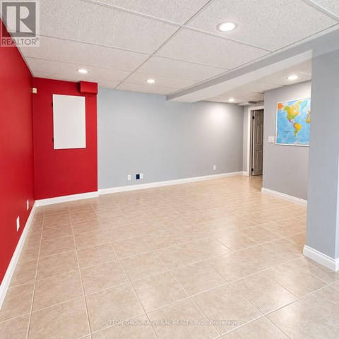 A room with red and grey walls and a world map on the wall.