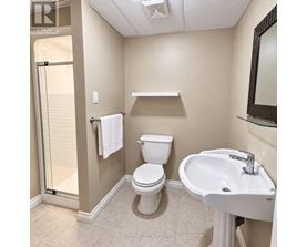 A white toilet sits next to a sink in a bathroom.