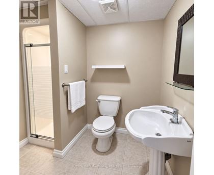 A white toilet sits next to a sink in a bathroom.