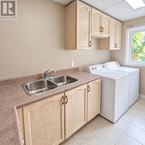 A kitchen with wooden cabinets and a white dishwasher.