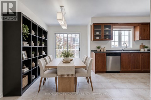 A modern kitchen with a dining table set for six.