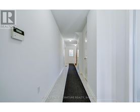 A hallway with a Royal LePage sign on the wall.