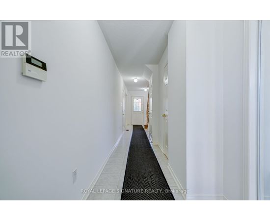 A hallway with a Royal LePage sign on the wall.