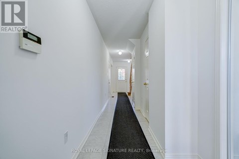 A hallway with a Royal LePage sign on the wall.