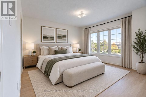 A bedroom with a large bed and a plant.