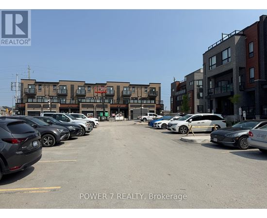 A parking lot with cars and apartment buildings in the background.