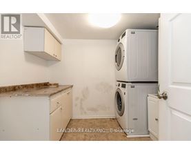 A laundry room with a washer and dryer stacked on top of each other.