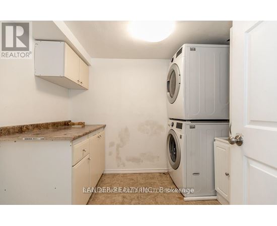 A laundry room with a washer and dryer stacked on top of each other.