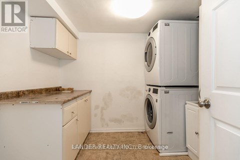 A laundry room with a washer and dryer stacked on top of each other.