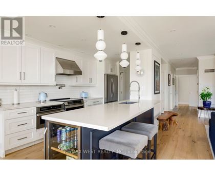 A modern kitchen with white cabinets and a large island.