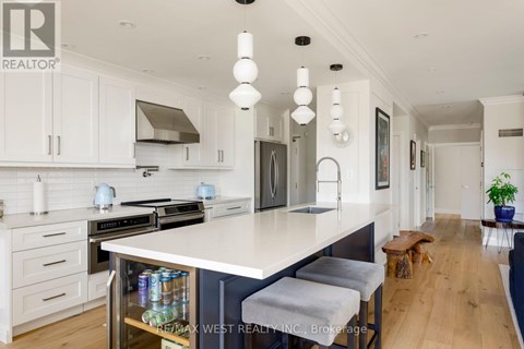 A modern kitchen with white cabinets and a large island.