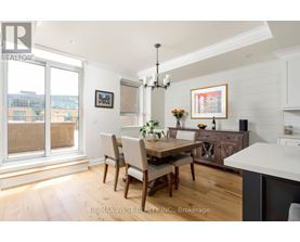 A dining room with a wooden table and chairs.