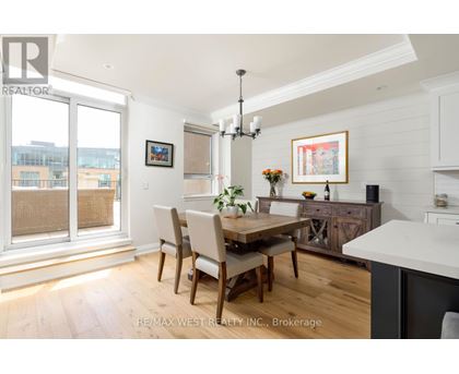 A dining room with a wooden table and chairs.