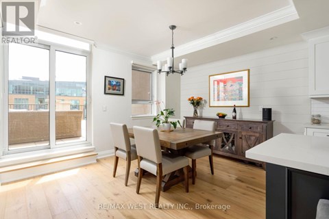 A dining room with a wooden table and chairs.
