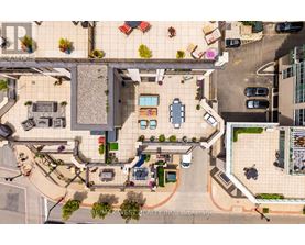 A bird's eye view of a courtyard with a pool and a building with the sign "REALTOR".