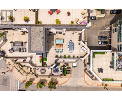 A bird's eye view of a courtyard with a pool and a building with the sign "REALTOR".