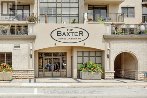 The front of a building called The Baxter with a balcony and flower pots.